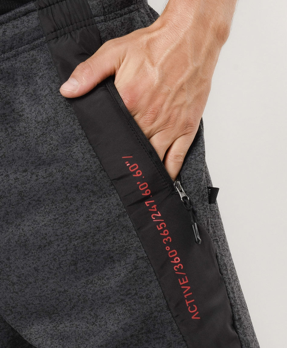 Pantal&oacute;n de buzo hombre detalles naranjos